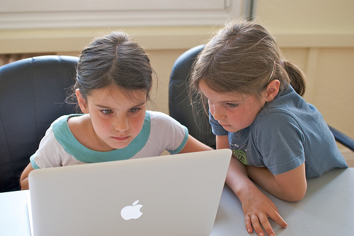 photo of two girls joyfully collaborating